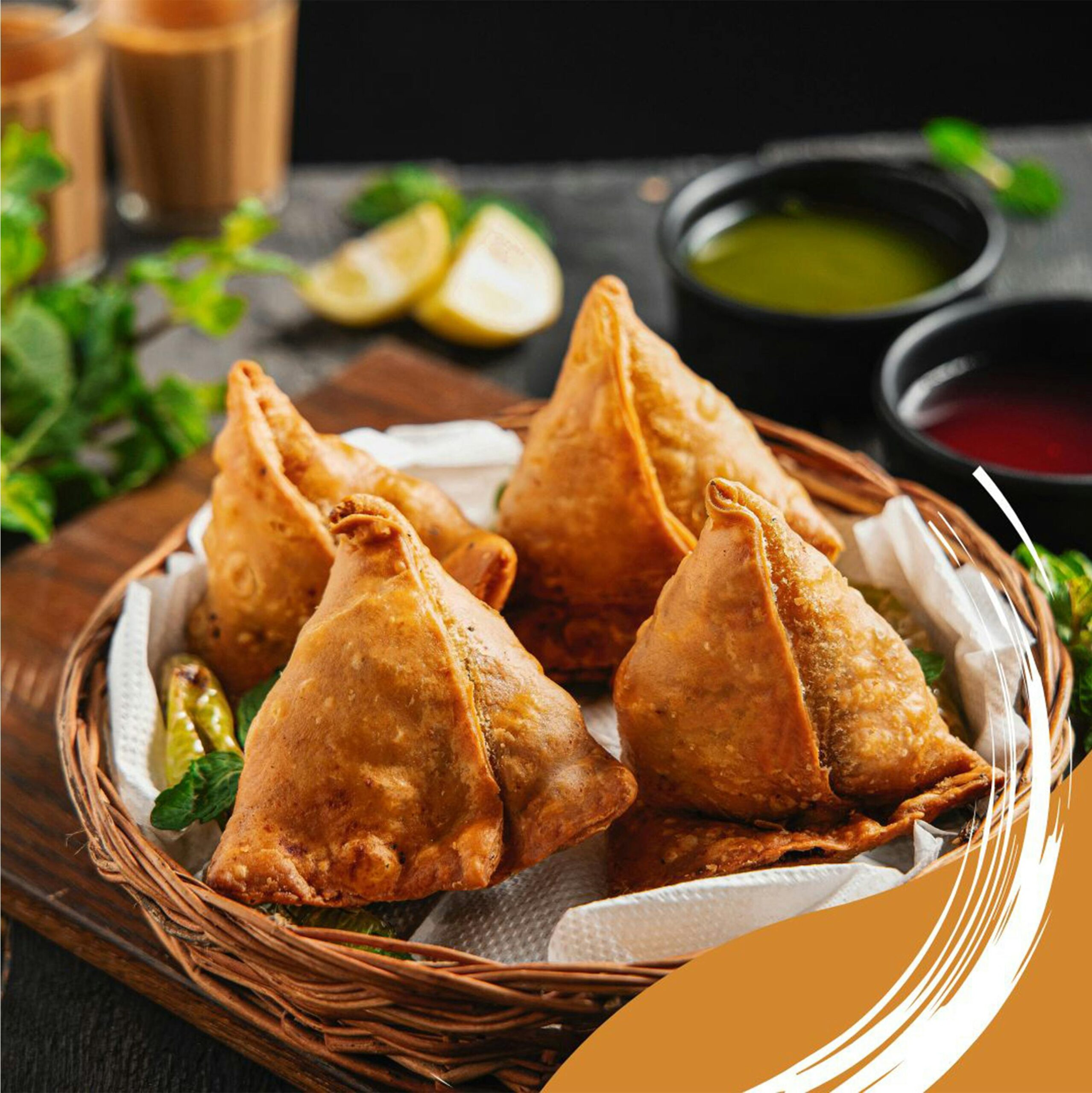A tempting plate of crispy samosas with mint and tamarind chutney, perfect for a snack or appetizer.